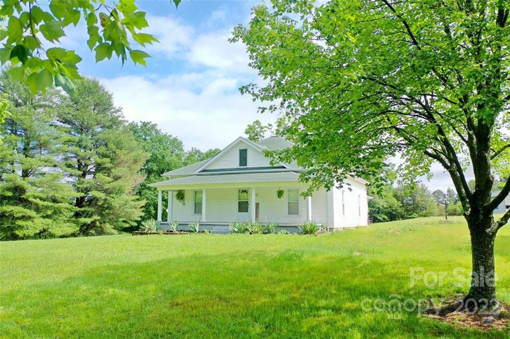 2139 Quaker Road Siloam, NC 27047 - Photo 2 of 35 a view of house with a garden