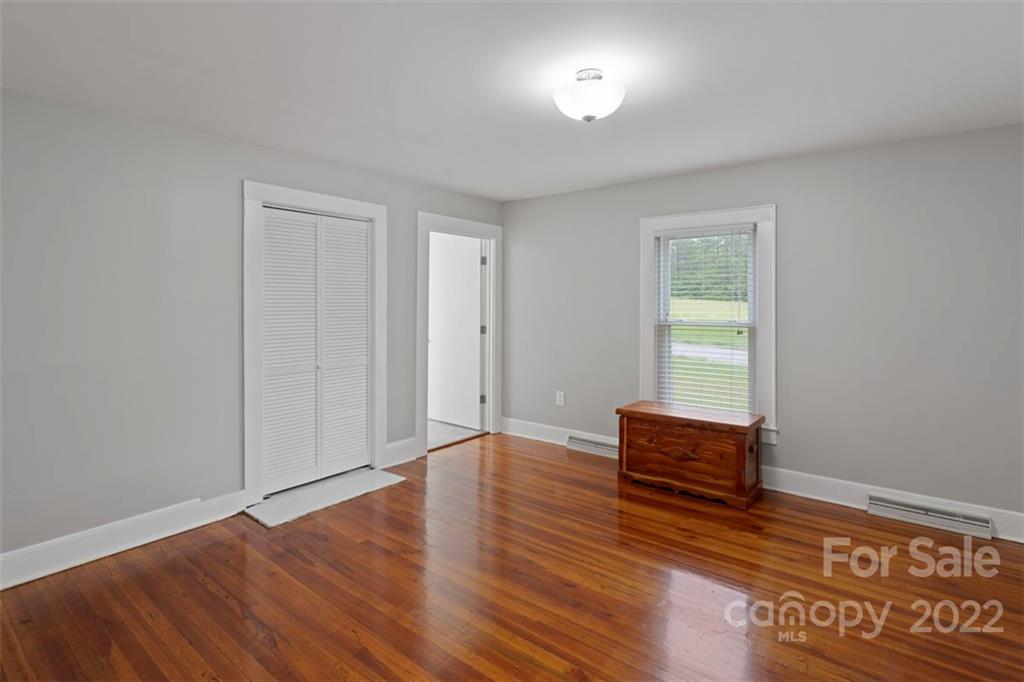 2139 Quaker Road Siloam, NC 27047 - Photo 27 of 35 a view of room with hardwood floor and cabinet