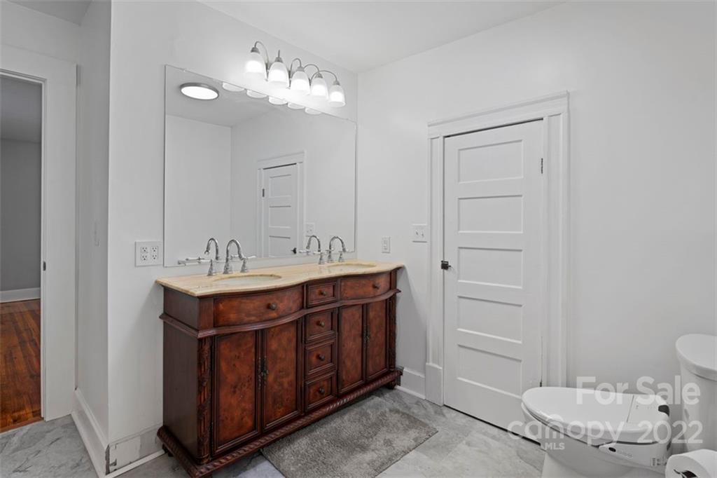 2139 Quaker Road Siloam, NC 27047 - Photo 28 of 35 a bathroom with a sink and a mirror