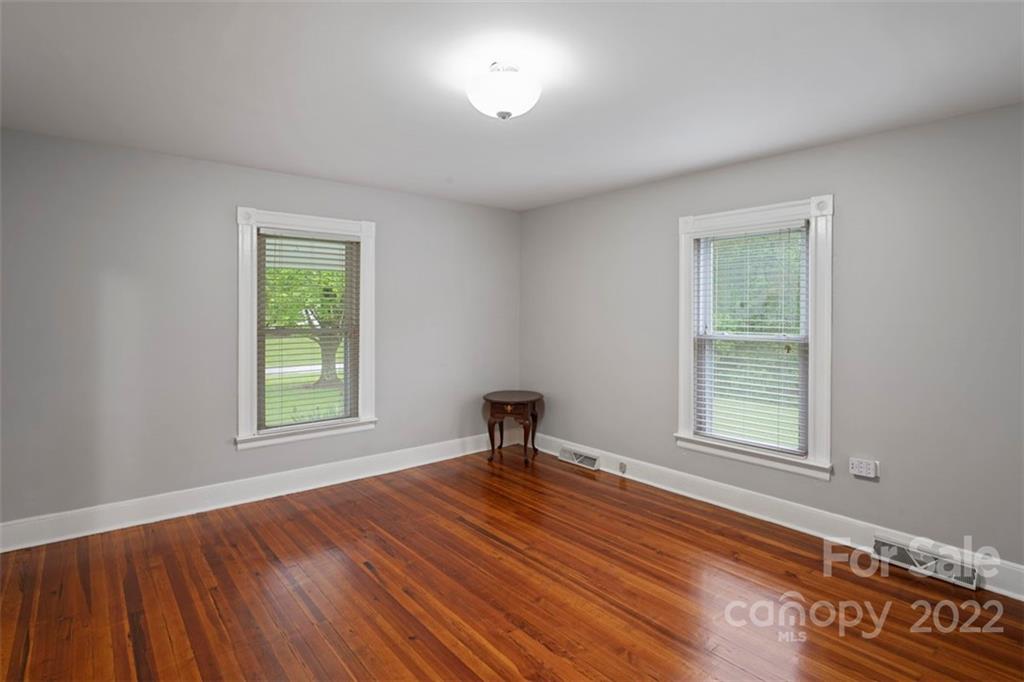 2139 Quaker Road Siloam, NC 27047 - Photo 30 of 35 an empty room with windows and hardwood