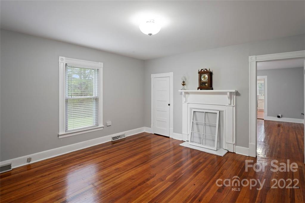 2139 Quaker Road Siloam, NC 27047 - Photo 31 of 35 a view of empty room with wooden floor and fan