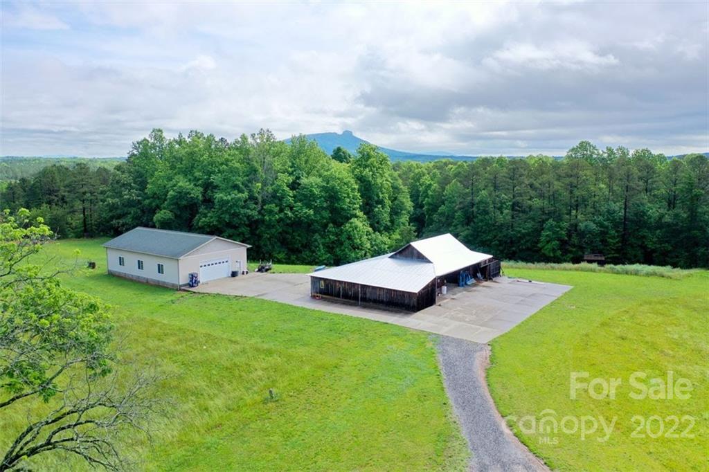 2139 Quaker Road Siloam, NC 27047 - Photo 4 of 35 a aerial view of a house with swimming pool and trees around