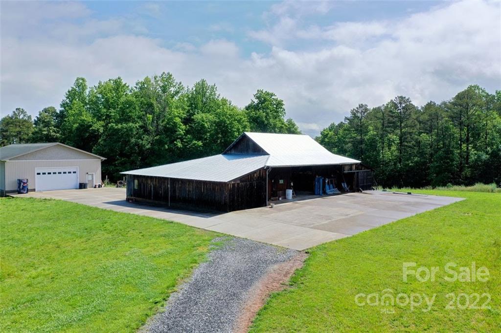 2139 Quaker Road Siloam, NC 27047 - Photo 10 of 35 a aerial view of a house with yard and trees in the background