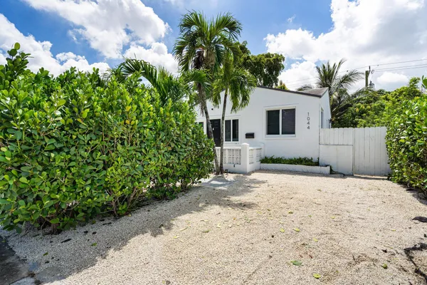 a front view of a house with a yard and a garage