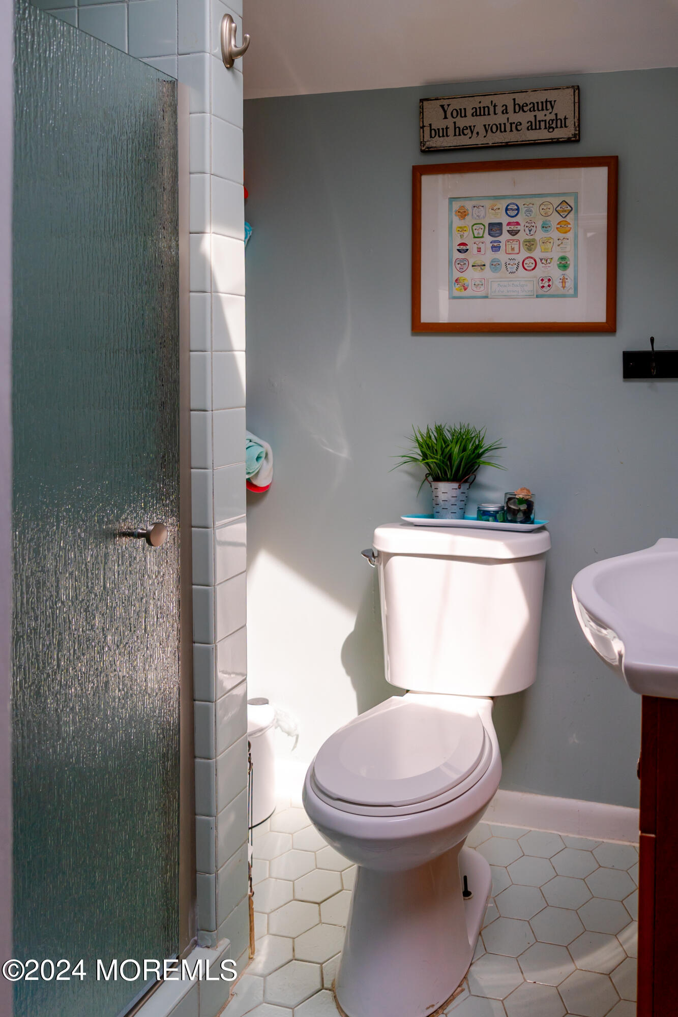 18 Valentine Street, Unit REAR Monmouth Beach, NJ 07750 - Photo 9 of 13 a white toilet sitting next to a bathroom sink and a mirror