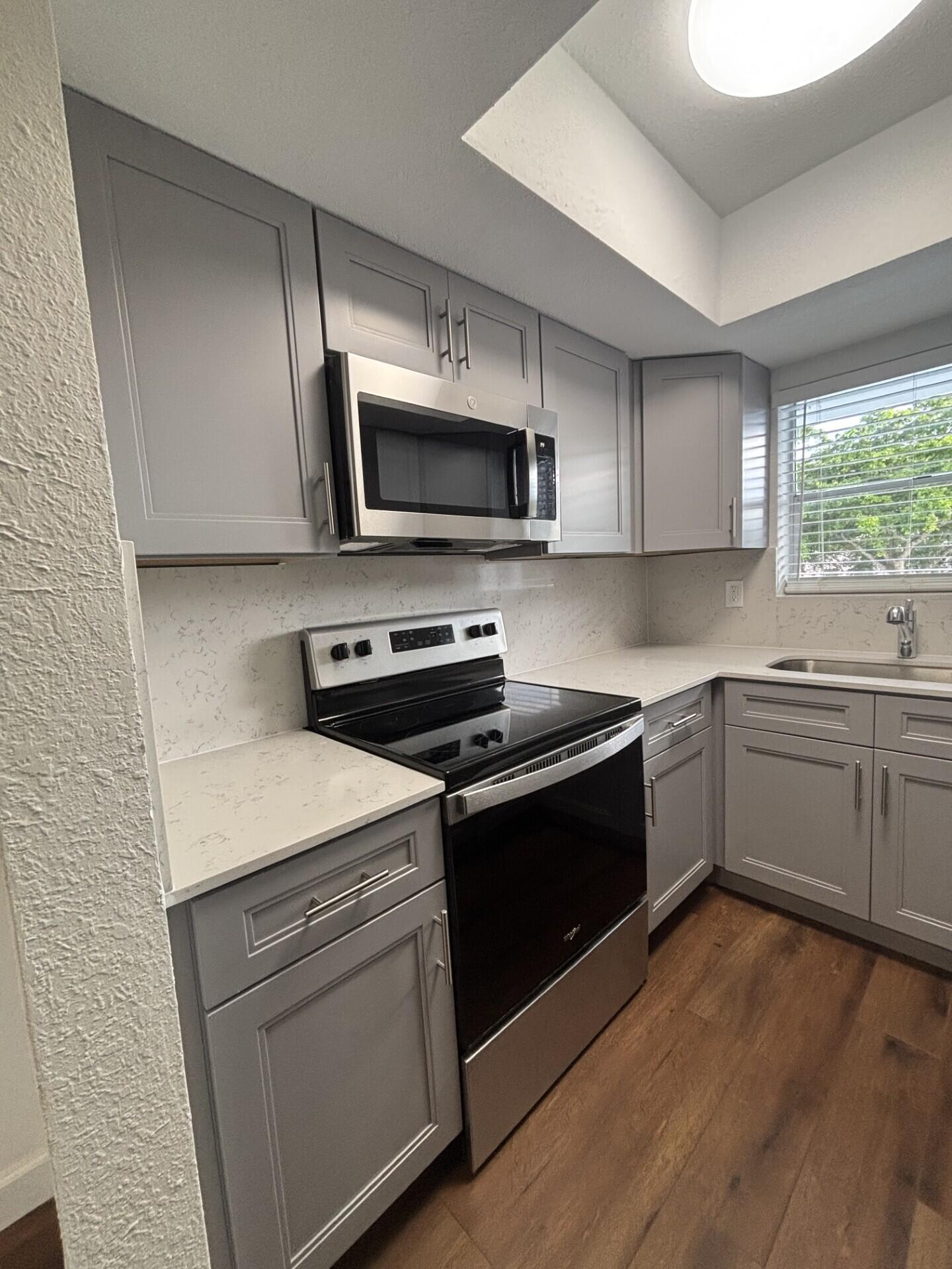 3510 Harrison Street, Unit 12 Hollywood, FL 33021 - Photo 13 of 18 a kitchen with a sink stove and microwave