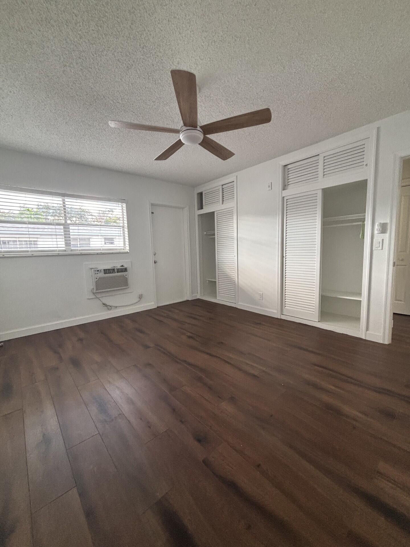 3510 Harrison Street, Unit 12 Hollywood, FL 33021 - Photo 6 of 18 a view of empty room with wooden floor and fan