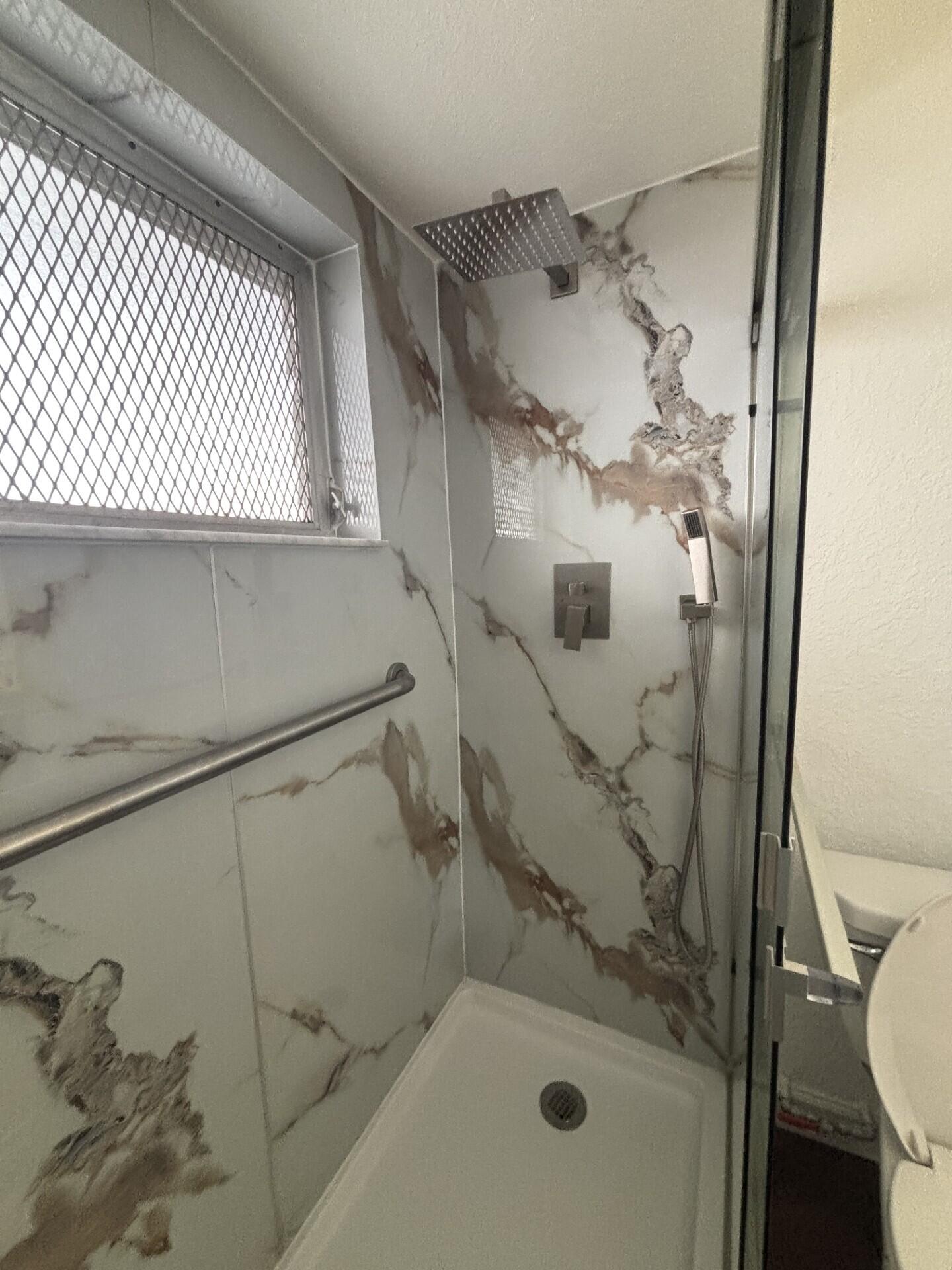 3510 Harrison Street, Unit 12 Hollywood, FL 33021 - Photo 8 of 18 a bathroom with a sink toilet and shower