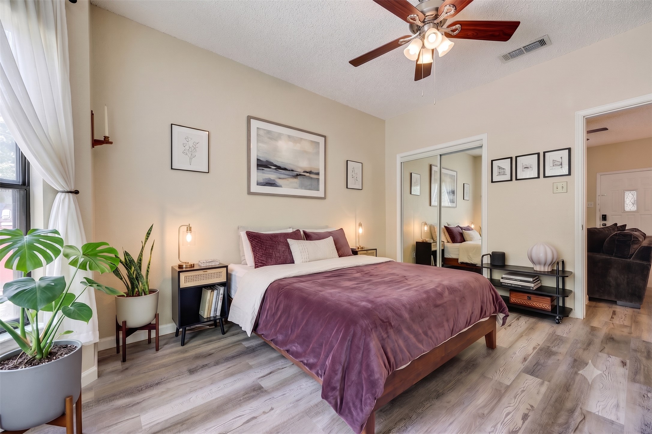 3011 Fruth Street, Unit 101 Austin, TX 78705 - Photo 8 of 14 Comfortable sleeping space featuring wood-look flooring and a ceiling fan.