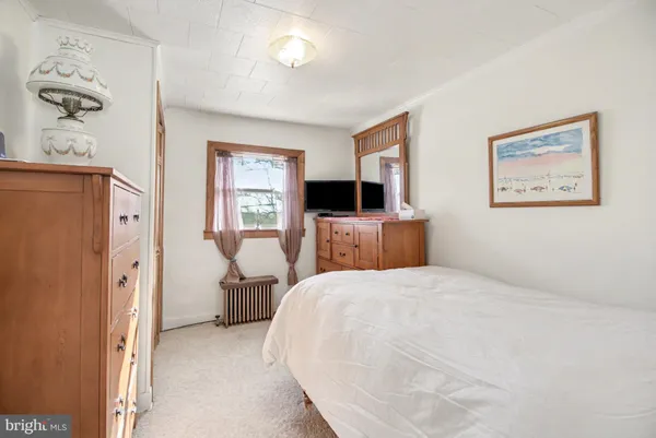 a bedroom with a bed furniture and a window
