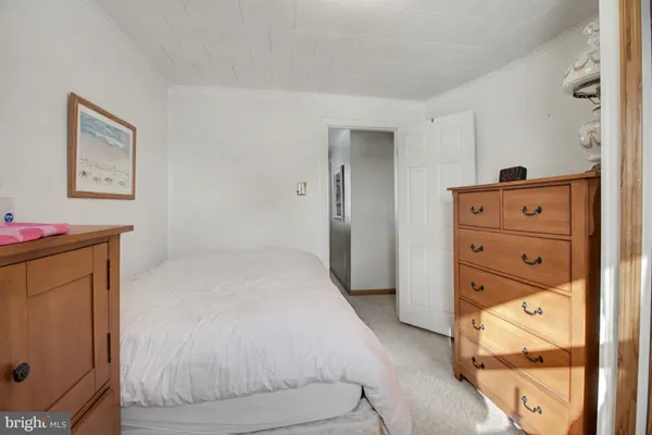 a bedroom with a bed and a mirror