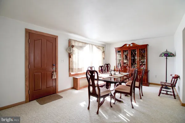 a view of a dining room with furniture and window