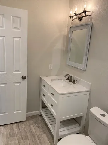 a bathroom with a sink toilet and vanity