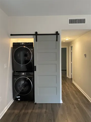a view of a hallway with washer and dryer