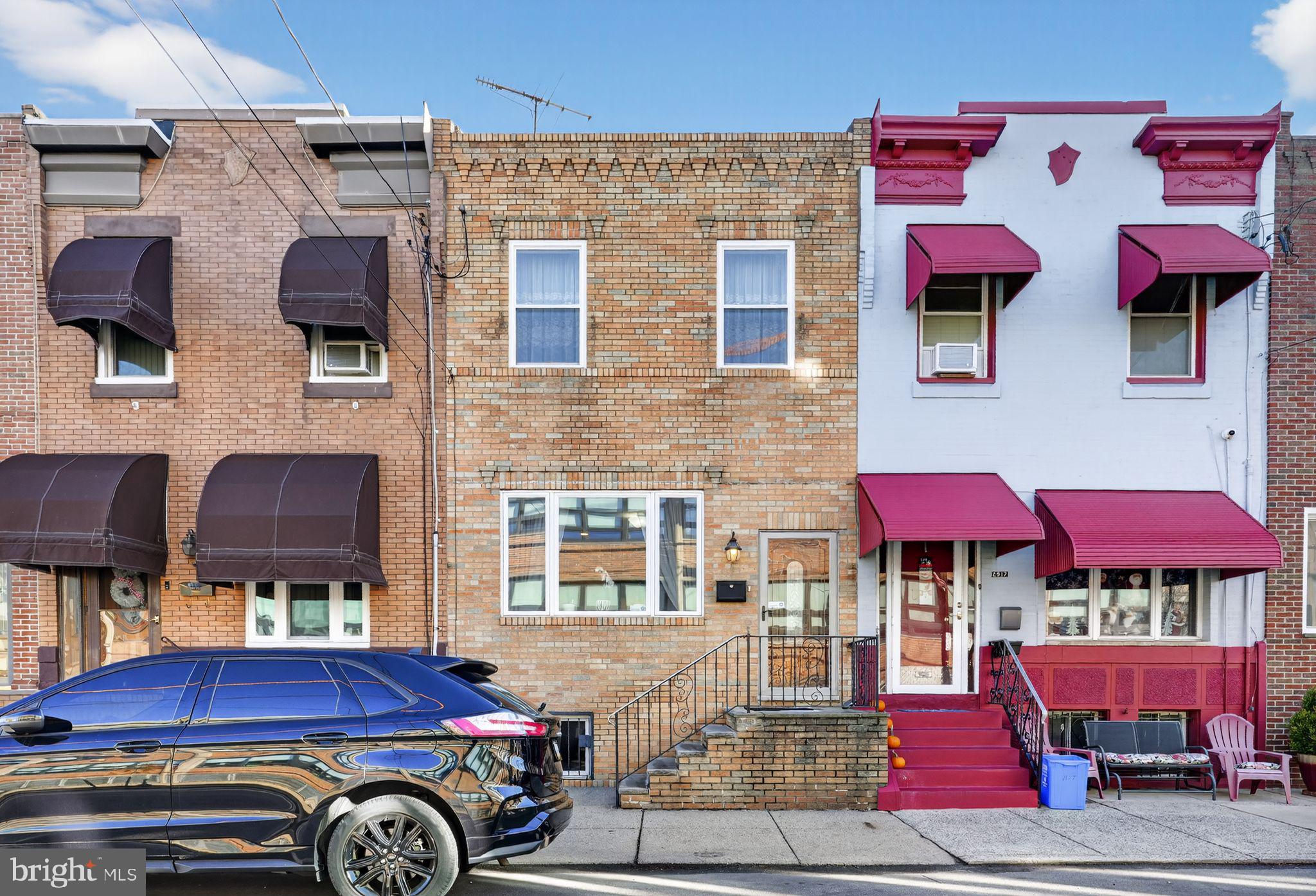 2515 South 16th Street Philadelphia, PA 19145 - Photo 1 of 29 a front view of a house with parking space and a car parked car