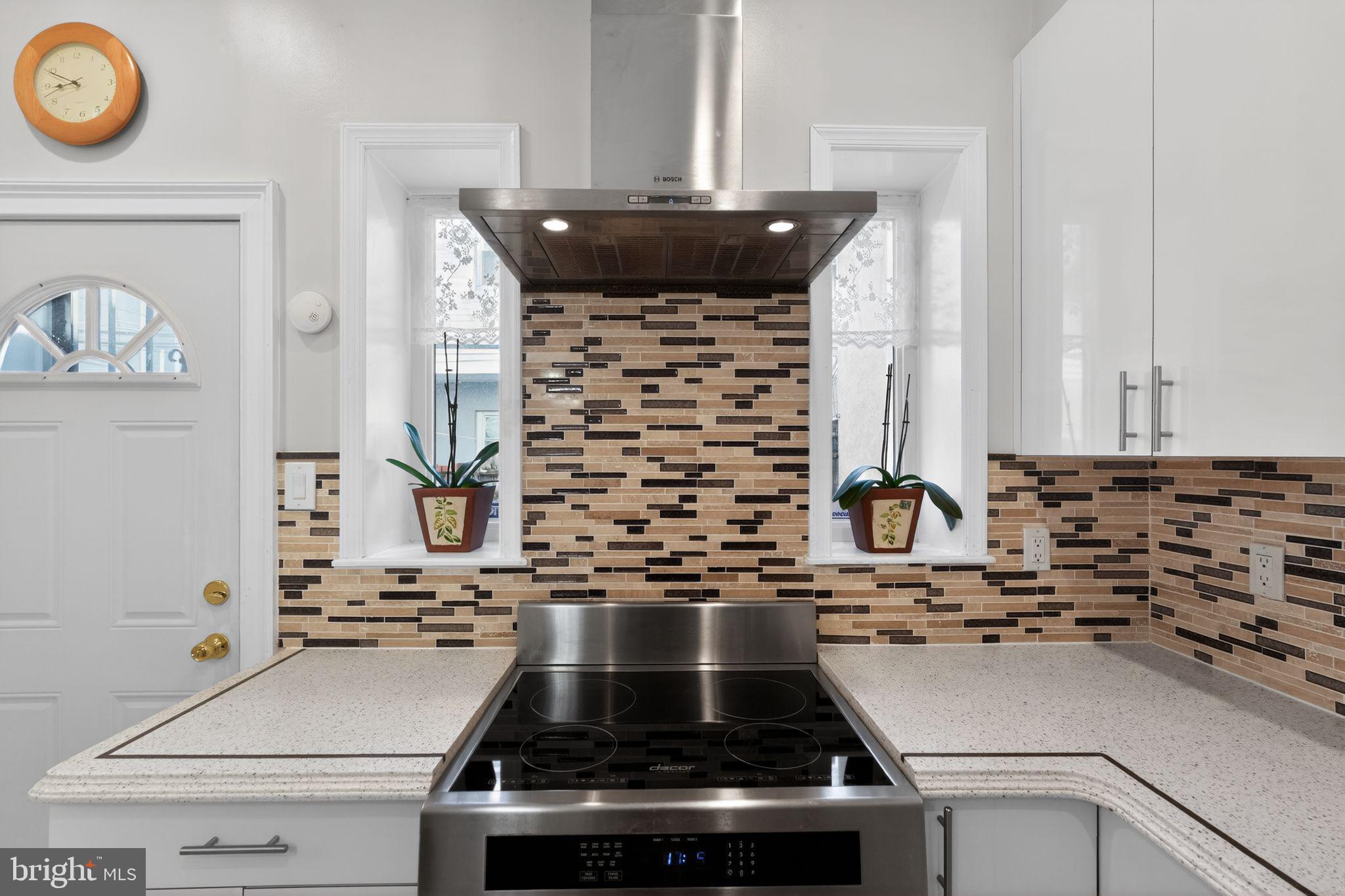 2515 South 16th Street Philadelphia, PA 19145 - Photo 12 of 29 a stove top oven sitting inside of a kitchen