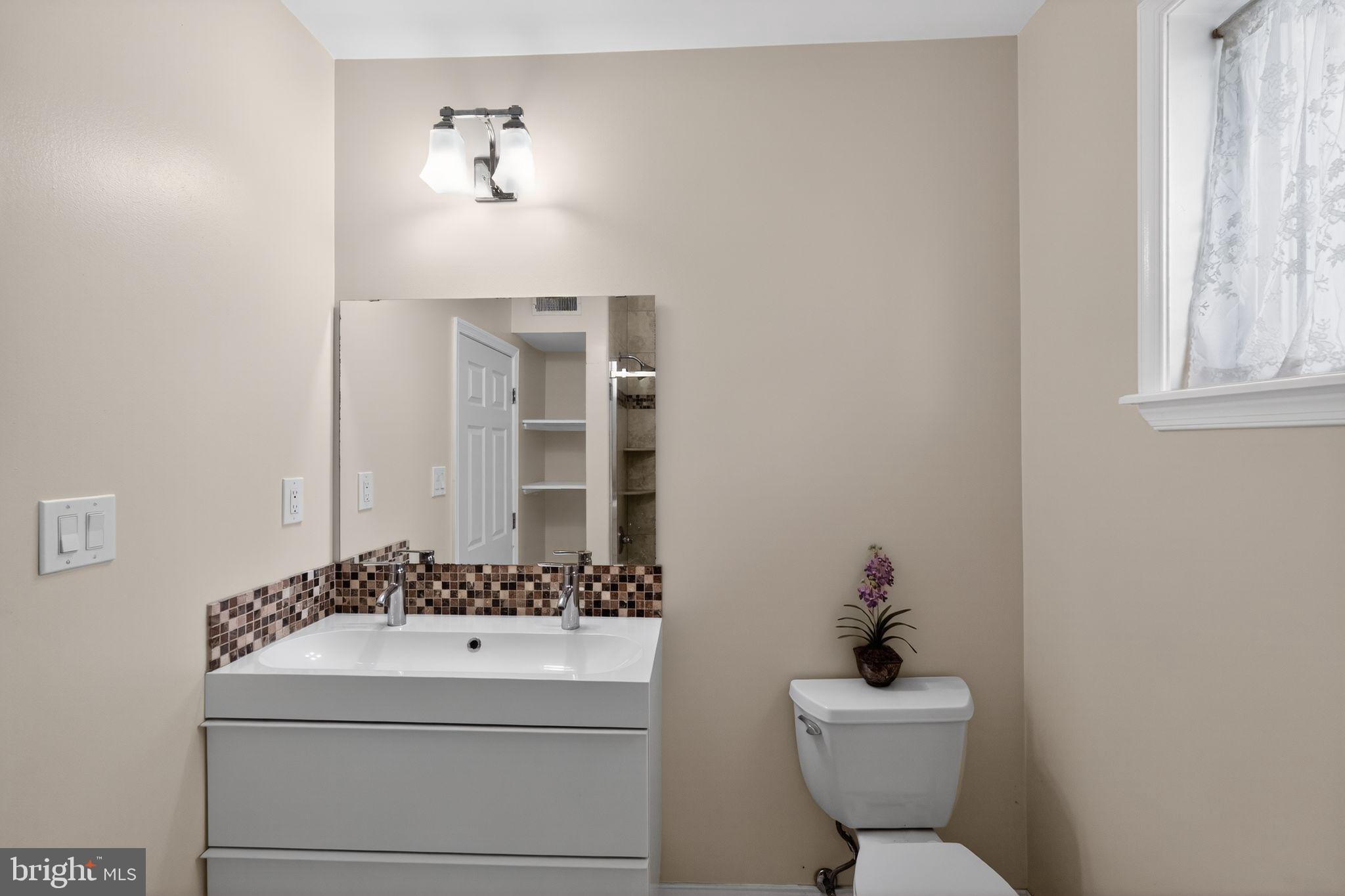 2515 South 16th Street Philadelphia, PA 19145 - Photo 20 of 29 a bathroom with a sink and a toilet