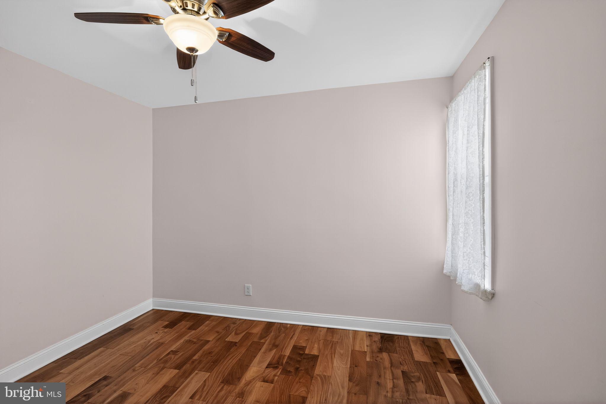 2515 South 16th Street Philadelphia, PA 19145 - Photo 23 of 29 an empty room with a wooden floor and windows
