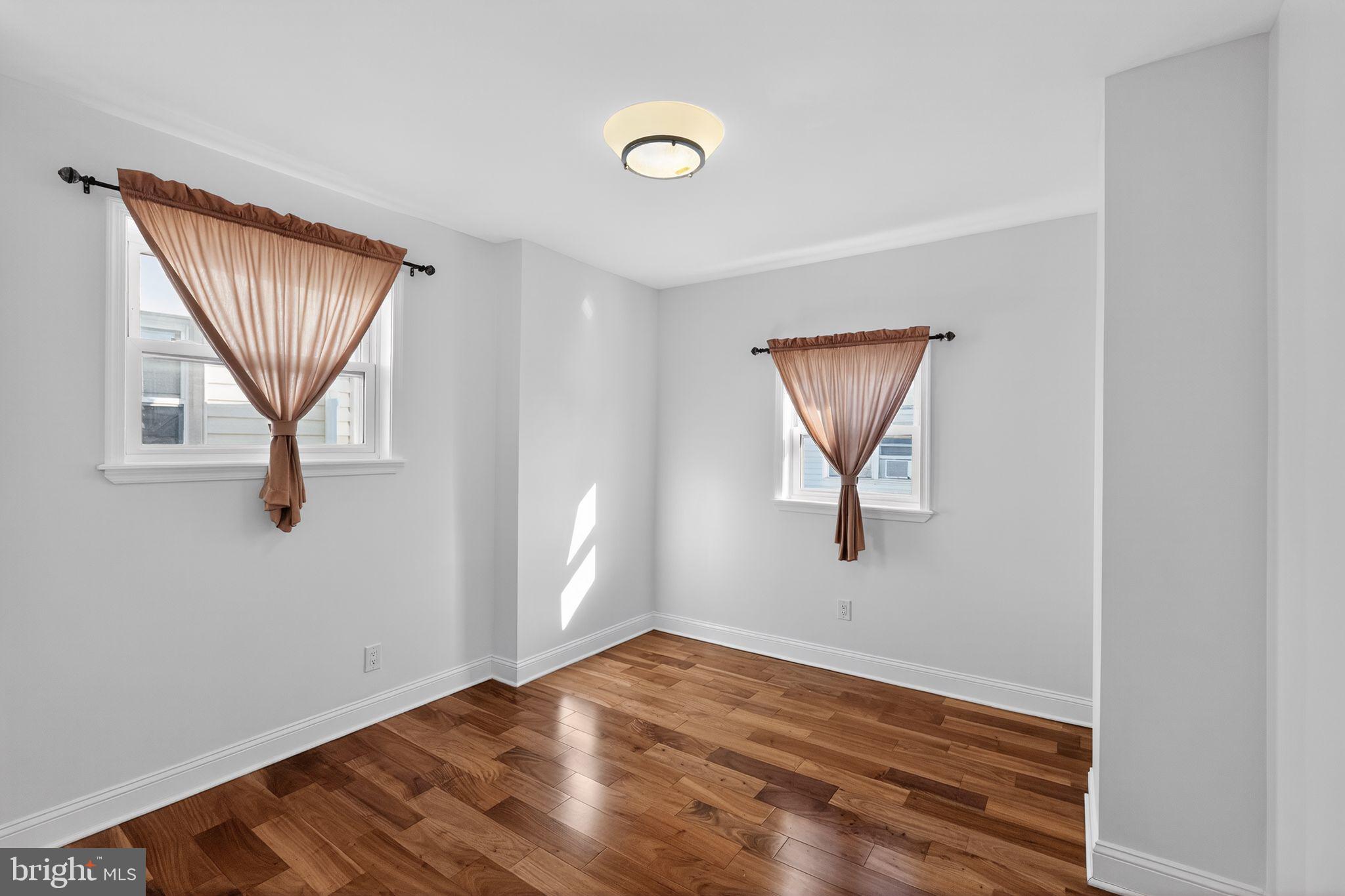 2515 South 16th Street Philadelphia, PA 19145 - Photo 25 of 29 an empty room with wooden floor and windows
