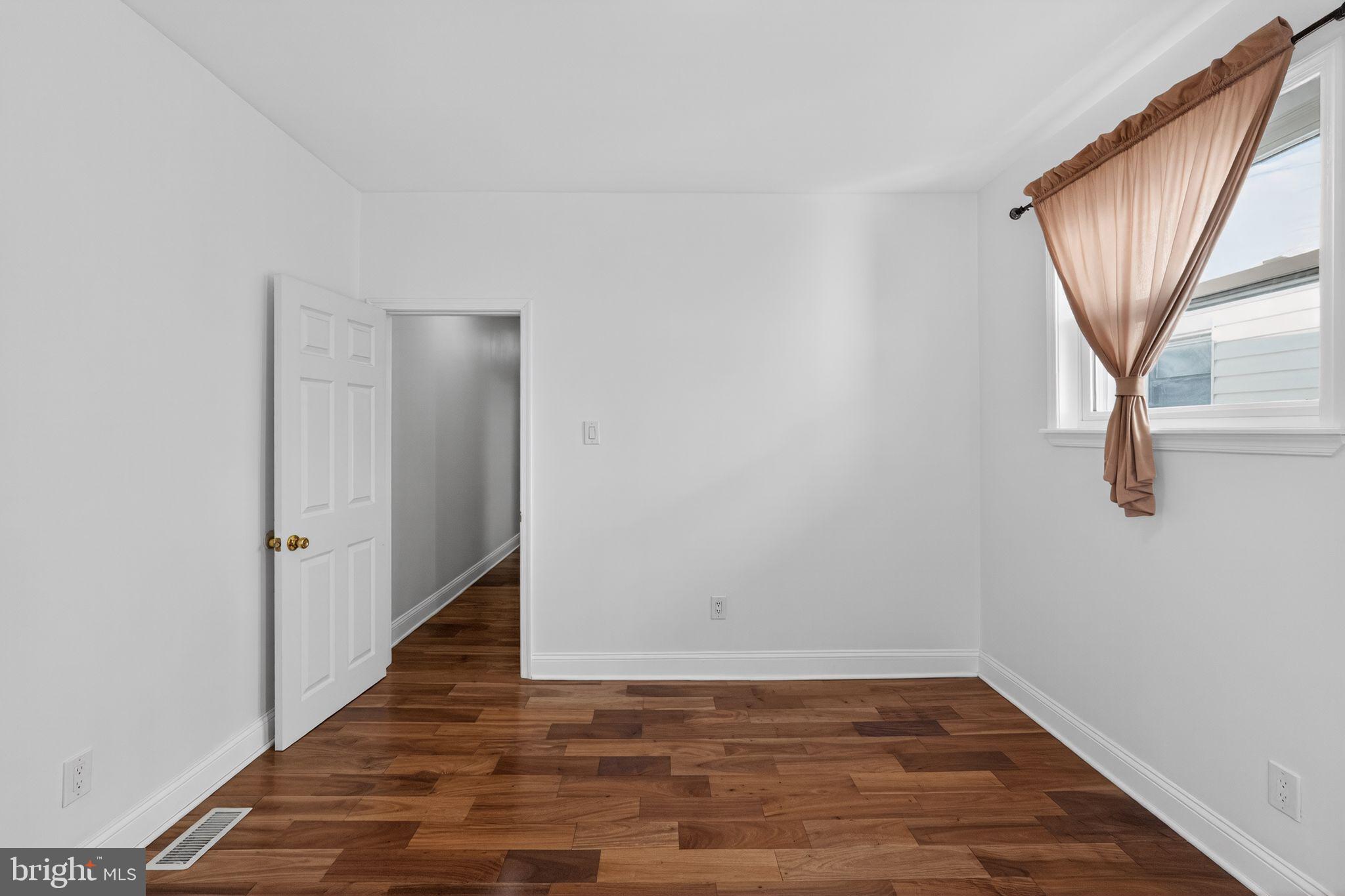 2515 South 16th Street Philadelphia, PA 19145 - Photo 26 of 29 a view of an empty room with wooden floor and a window