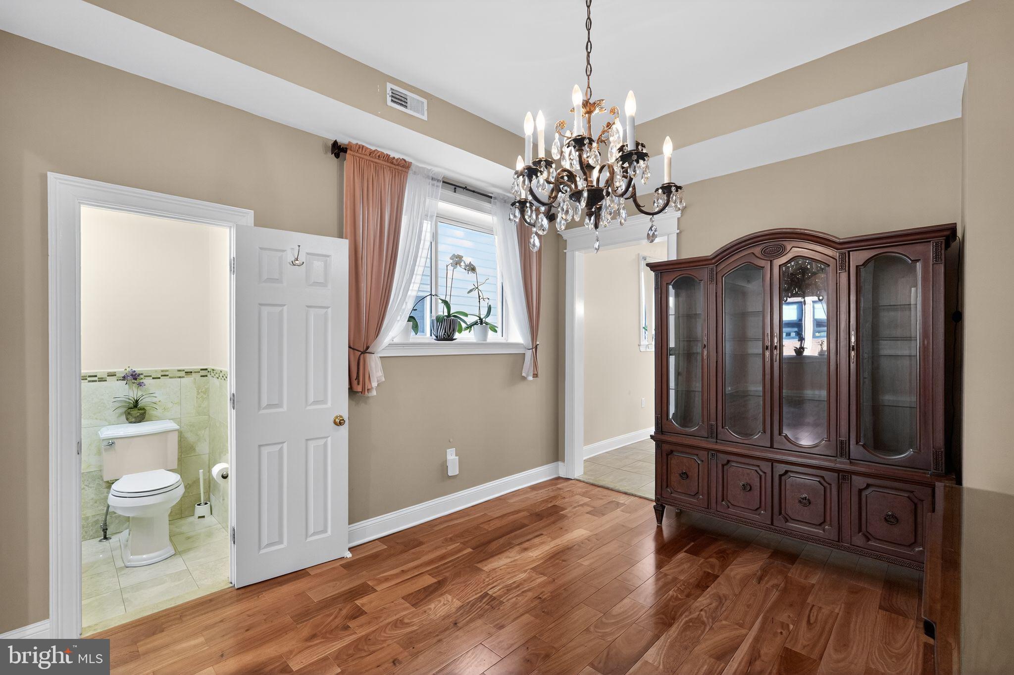 2515 South 16th Street Philadelphia, PA 19145 - Photo 7 of 29 a view of a livingroom with a furniture wooden floor and window