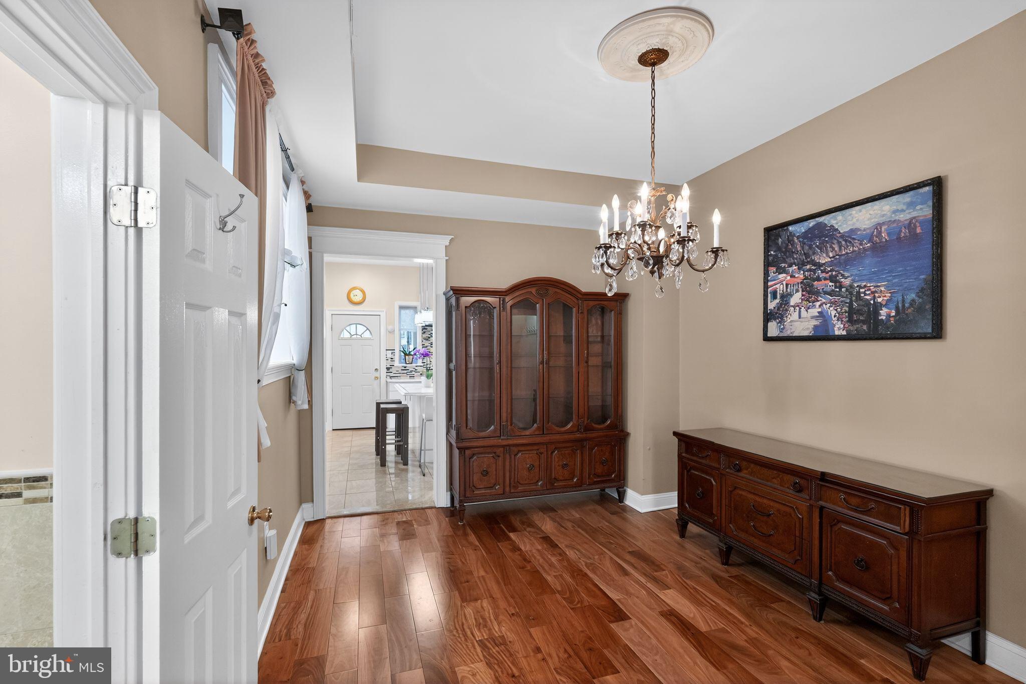 2515 South 16th Street Philadelphia, PA 19145 - Photo 9 of 29 a view of a livingroom with wooden floor and chandelier