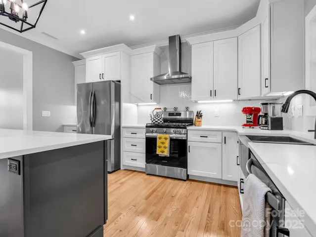 a kitchen with stainless steel appliances a refrigerator stove and sink