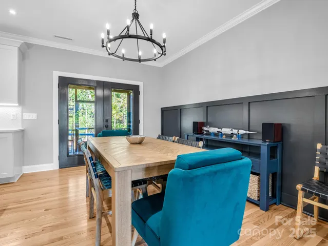 a room with furniture a chandelier and a window