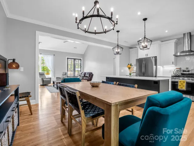 a view of a dining room with furniture wooden floor and chandelier