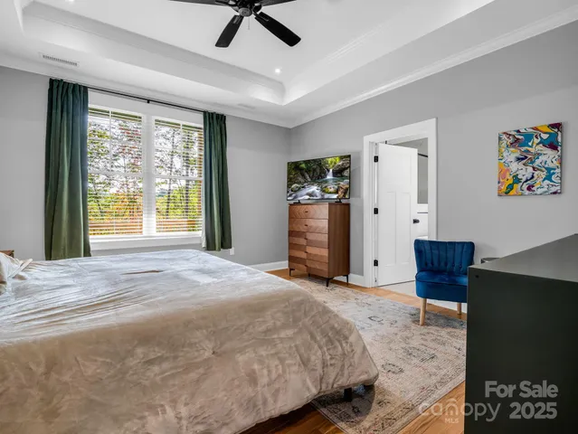 a bed room with a bed and a television