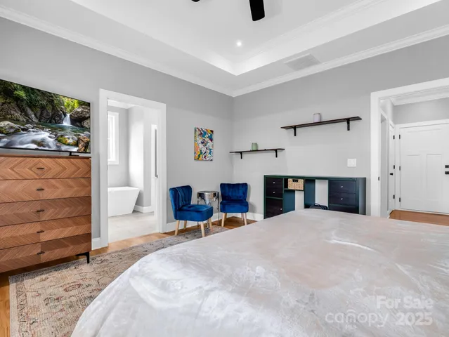 a large bedroom with a bed and a dresser