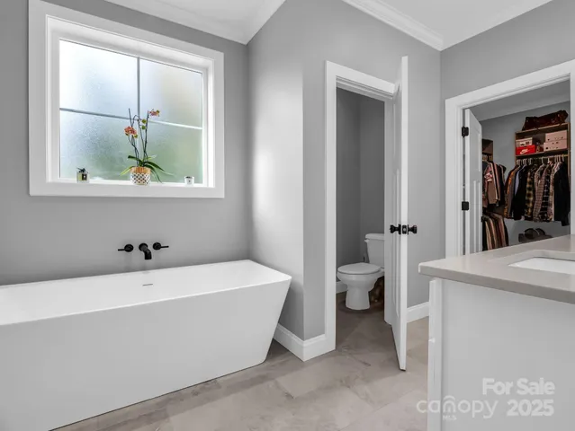 a bathroom with a bathtub and a window