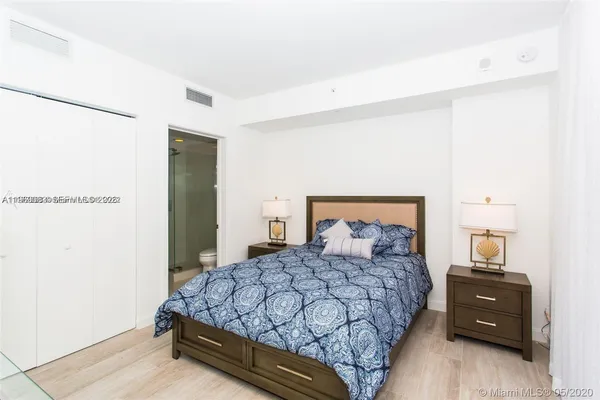 a bedroom with a bed and a night stand