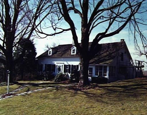 a view of a house with a yard covered with snow in a yard