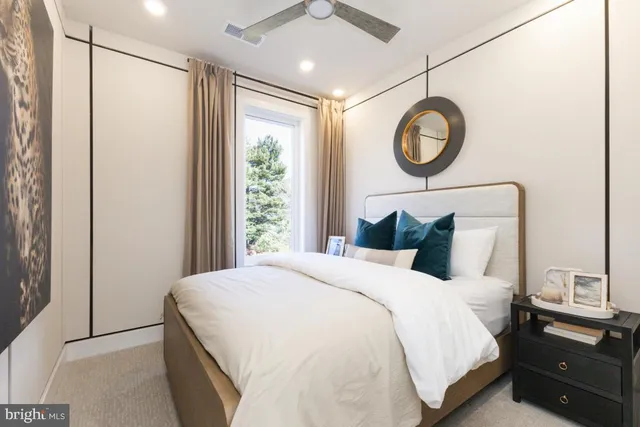 a bedroom with a large bed and a window