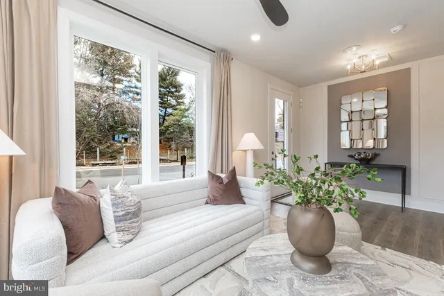 a living room with furniture potted plant and windows