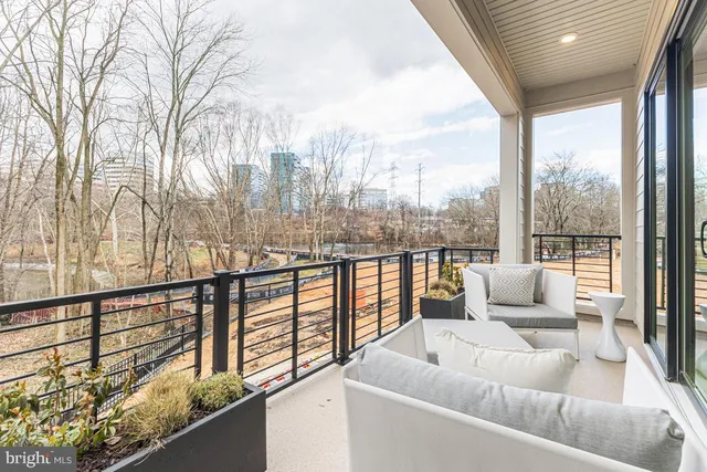 a balcony with furniture and a view of lake