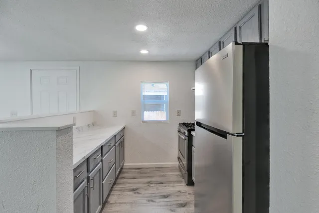 a bathroom with a granite countertop sink and shower