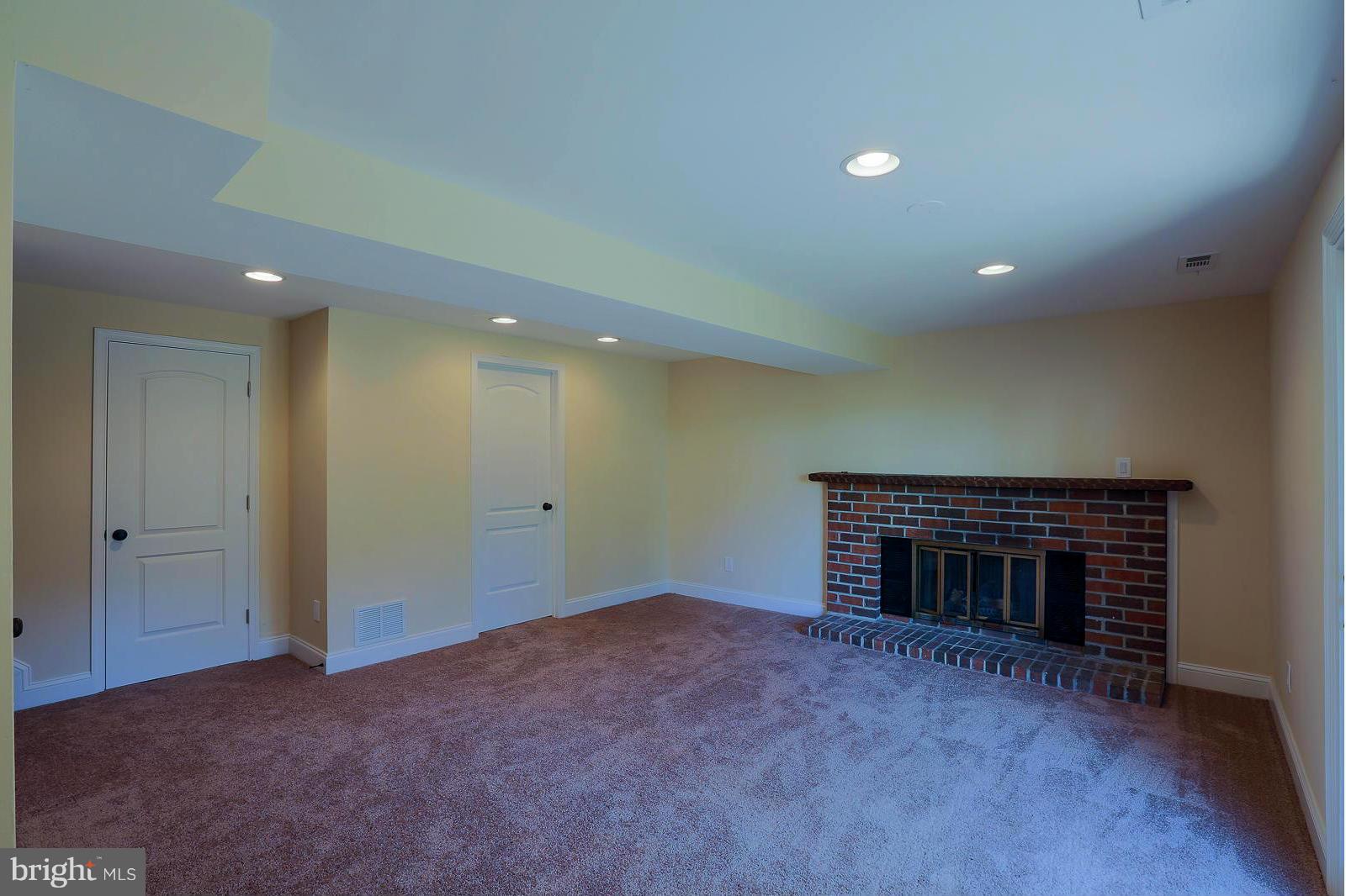 9326 Tulsemere Road Randallstown, MD 21133 - Photo 22 of 30 a view of an empty room with a fireplace
