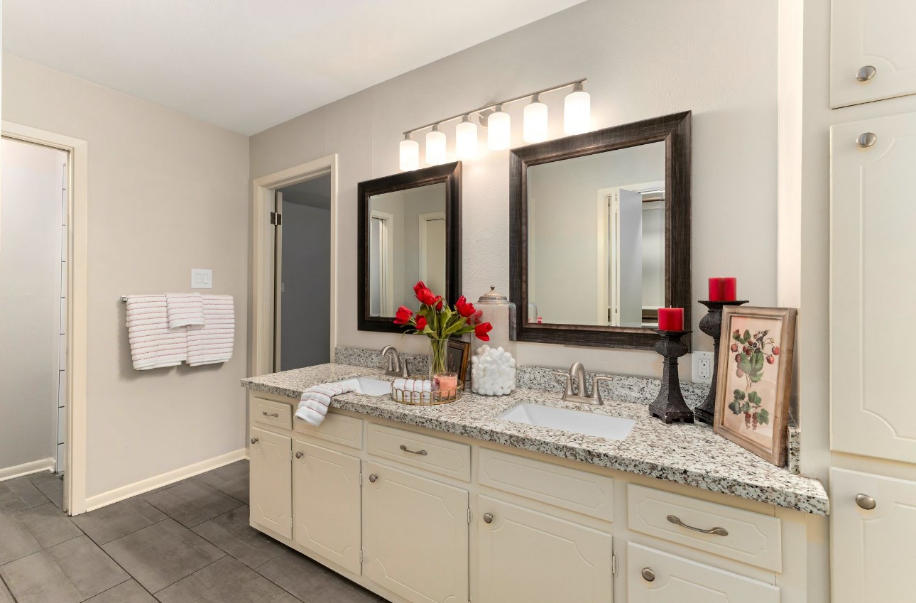 1609 Longhofer Street Brenham, TX 77833 - Photo 12 of 18 a bathroom with a double vanity sink and a mirror