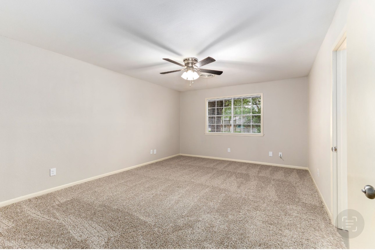 1609 Longhofer Street Brenham, TX 77833 - Photo 14 of 18 an empty room with windows and chandelier fan