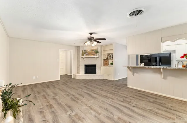 a view of a kitchen with microwave and cabinets