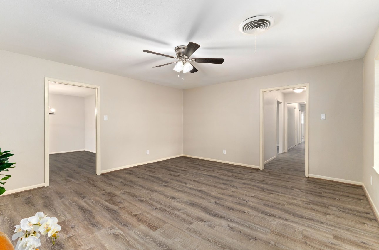 1609 Longhofer Street Brenham, TX 77833 - Photo 6 of 18 an empty room with wooden floor and ceiling fan