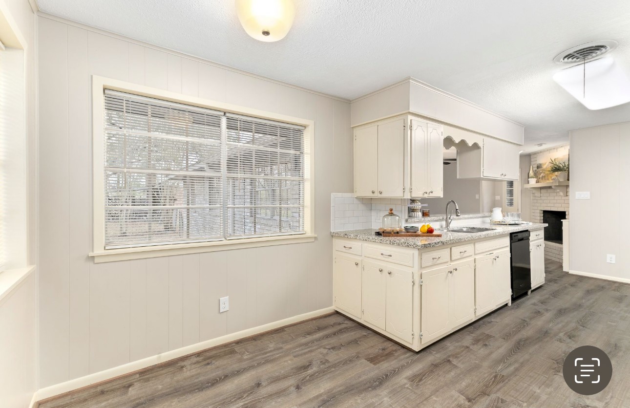 1609 Longhofer Street Brenham, TX 77833 - Photo 7 of 18 a kitchen with white cabinets and sink