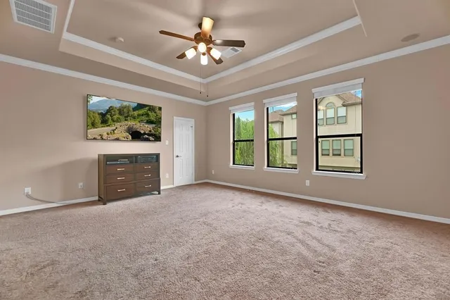 a view of an empty room with a fireplace and a window