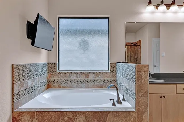 a bathroom with a bathtub and a shower