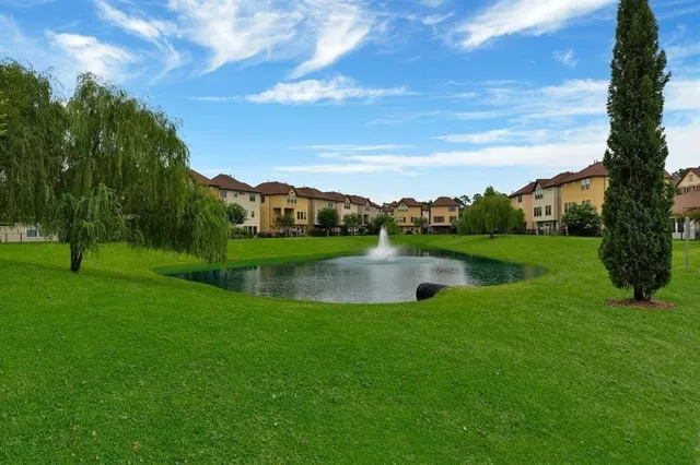 a view of a lake with a yard in front of it