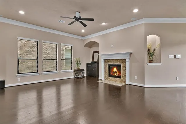 a view of an empty room with a fireplace and a window