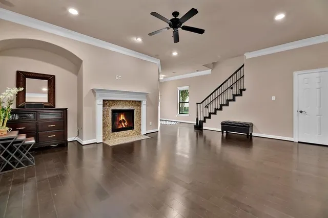 a view of empty room with wooden floor fireplace and windows