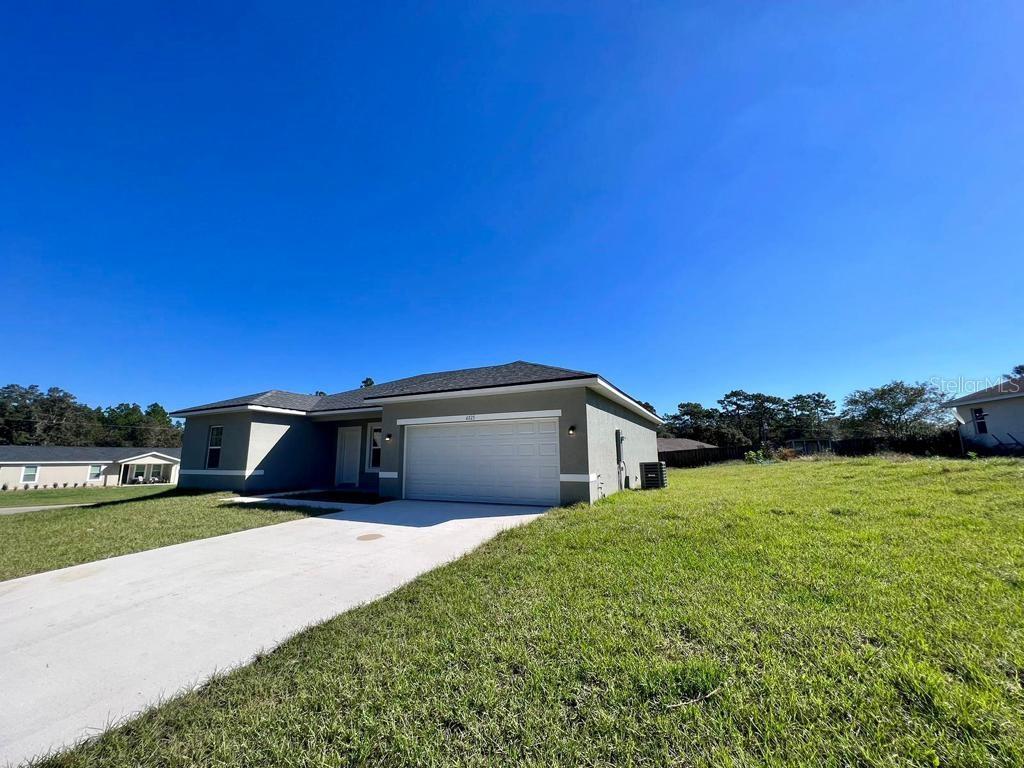 6325 Southwest 144th Lane Road Ocala, FL 34473 - Photo 18 of 31 a view of a house with a big yard